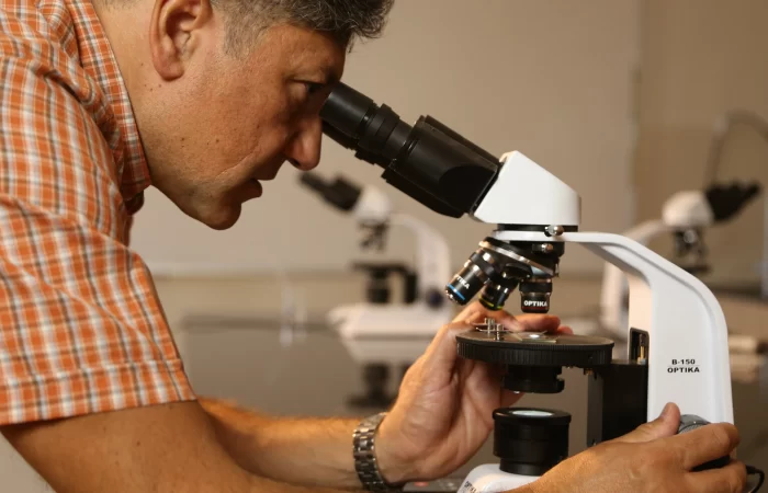 nabil looking through microscope